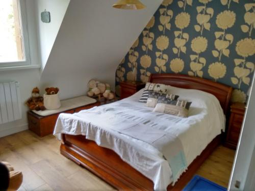 a bedroom with a bed with a blue and yellow wallpaper at Bois de Kador in Morgat