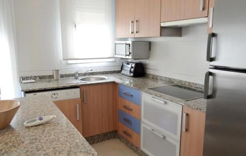 a kitchen with white appliances and a counter top at Garrucha Centro y Mar in Garrucha