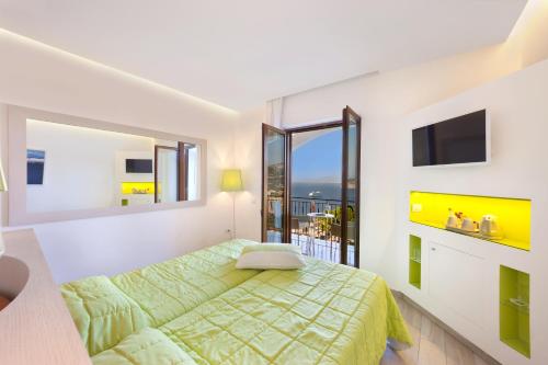 a bedroom with a bed and a large window at Grand Hotel President in Sorrento