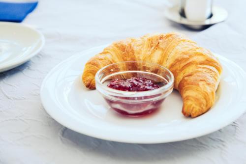 a plate with a croissant and a bowl of jam at Hotel Klinglhuber in Krems an der Donau