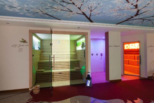 a room with a staircase with purple and pink lights at Hotel Europa in San Martino di Castrozza