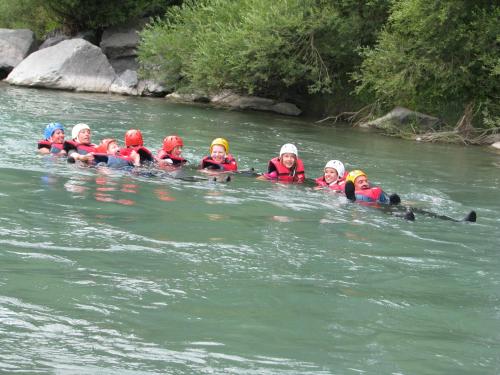 a group of children are in the water at Sölle Homes Nassfeld in Sonnenalpe Nassfeld