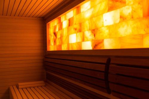 a sauna with a wooden bench in a room at Hotel Europa in San Martino di Castrozza