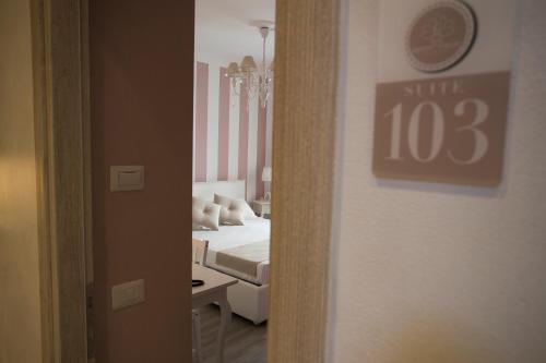 a hospital room with a bed and a mirror at Les Suites Magnolia in Olbia