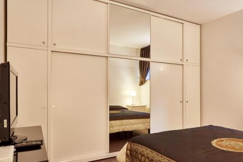 a bedroom with white cabinets and a bed at Il Gioiellino in Sorrento