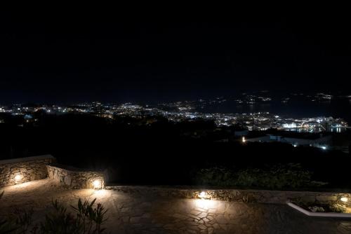 a view of a city at night with lights at Bellou Suites in Mýkonos City