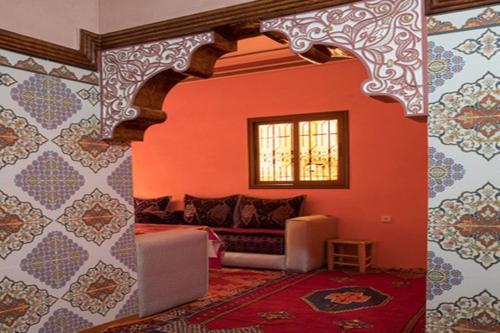 a living room with a couch and a window at Dar Amadine in Imlil