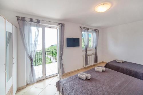 Postel nebo postele na pokoji v ubytování Apartmani Sandra Rovini