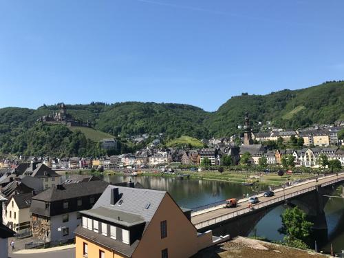 a city with a bridge over a river and a town at Hotel Traumblick in Cochem