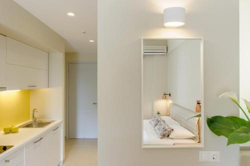 a kitchen with a mirror next to a sink at Yellow house in Parga