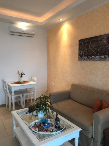a living room with a couch and a table at Stampalia Luxury Studios in Astypalaia Town