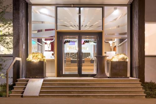 an entrance to a mall with a glass door at AMH Airport-Messe-Hotel Stuttgart in Filderstadt