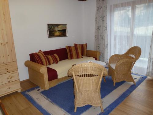 a living room with a couch and chairs and a table at Rainerhof in Dorfgastein