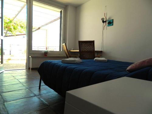 a room with a bed and a table and a window at Il Nido del Gabbiano in Vietri sul Mare