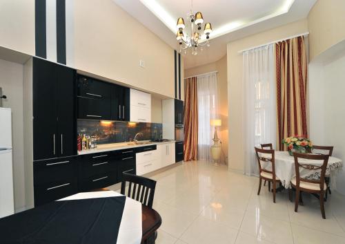 a kitchen with a table and a dining room at Queen Valery Hotel in Odesa