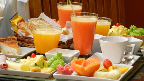 a tray of food with fruit and drinks on a table at Hotel Casa do Amarelindo in Salvador