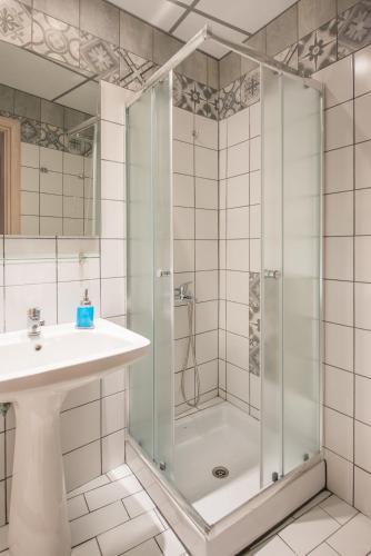 a bathroom with a shower and a sink at Villa Pipini Luxury Studios in Limenas