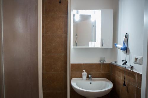 a bathroom with a sink and a mirror at La Residenza City in Rome