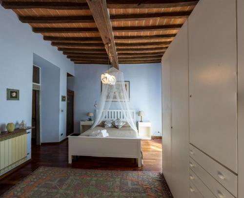 een slaapkamer met een bed en een houten plafond bij La Casa del Viaggiatore in Castiglion Fiorentino