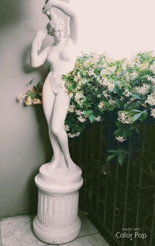 a statue of a woman standing on a pedestal at Hotel Alessandra in Garda