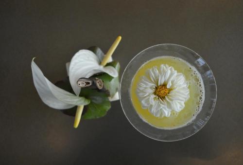 a drink with a white flower on top of it at Armani Hotel Milano in Milan