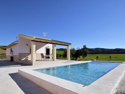 une villa avec une piscine en face d'une maison dans l'établissement Belvilla by OYO Casa Celeste, à Villanueva de la Concepción