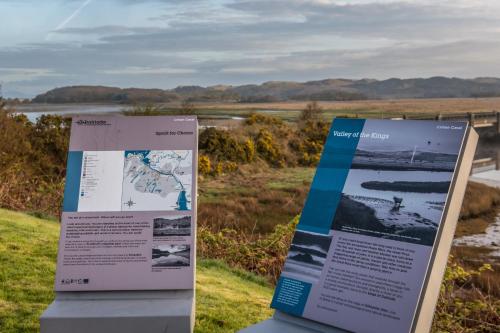 a interpretive sign in a field next to a river at Crinan Hotel in Crinan