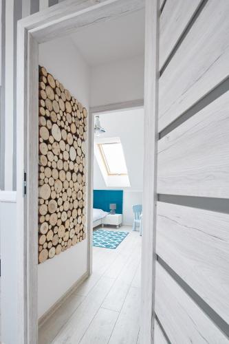a door leading into a room with a stack of logs at Nadmorski Zaułek in Jastrzębia Góra