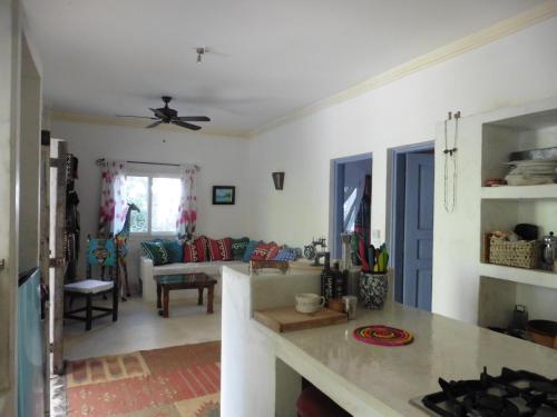 a kitchen and living room with a ceiling fan at Downtown Malindi Apartment in Malindi
