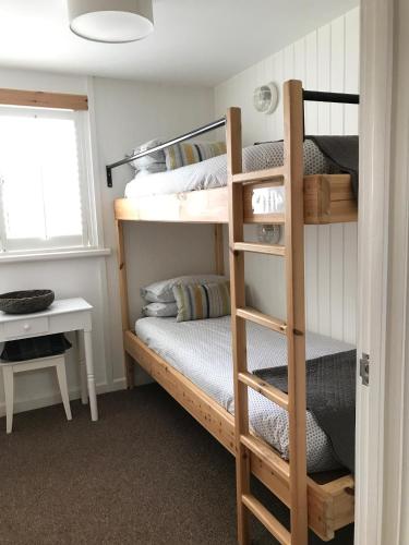 a bedroom with two bunk beds and a desk at The Gallery Two Bedroom Apartment in Oakham