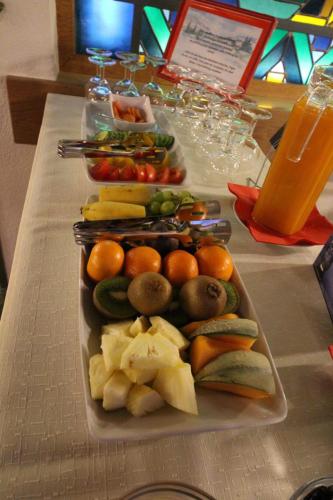 a tray of fruits and vegetables on a table at Hotel Garni Lärchenhof in Lech am Arlberg