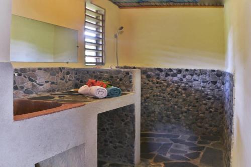 a kitchen with a counter with a sink and a counter top at Ylang hôtel in Ambondrona