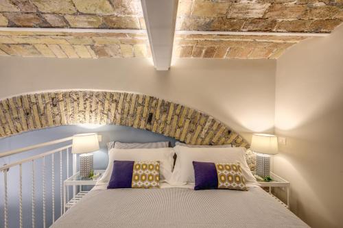 Ένα ή περισσότερα κρεβάτια σε δωμάτιο στο Domus Urbana