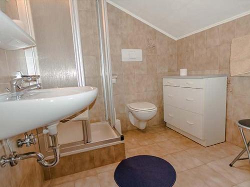 a bathroom with a sink and a toilet at Residence Rebgut in Tesimo