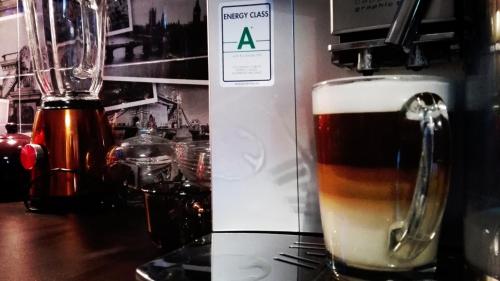 a glass of beer sitting next to a blender at Art Apartments in Poznań