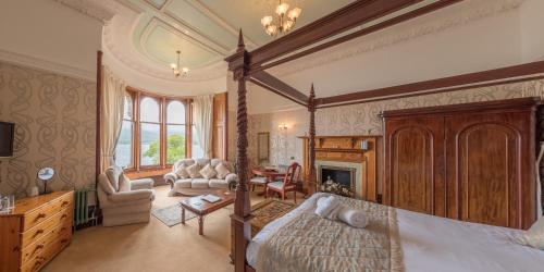 een slaapkamer met een hemelbed en een woonkamer bij Craigard House Hotel in Campbeltown