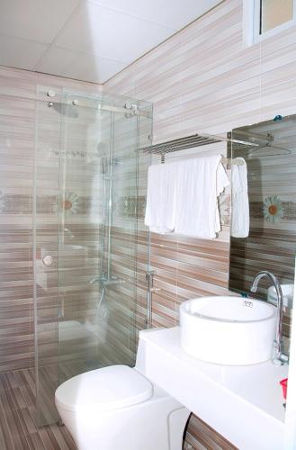 a bathroom with a toilet and a sink and a shower at Blue Sea Hotel 2 in Nha Trang