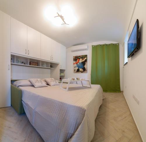 a bedroom with a large bed with a green curtain at Casa Rosanna in Maiori