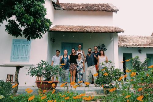 a group of people standing in front of a house at Vietnam Phuot Real Home in Kon Tum