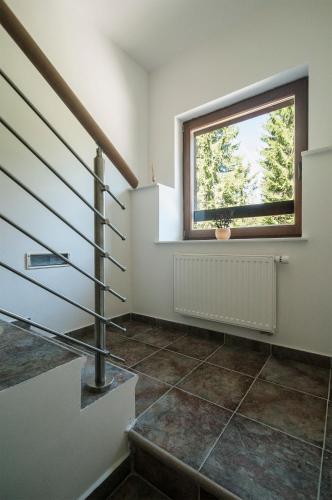 a staircase in a house with a window at Apartments Villa Vesna Pokljuka in Goreljek