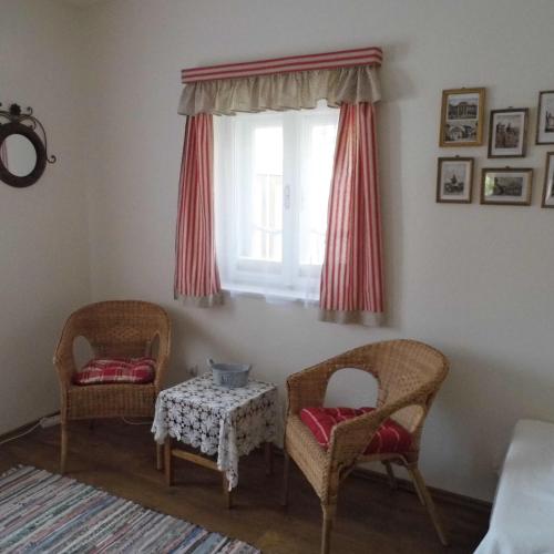 a room with two chairs and a table and a window at Helló Bogács in Bogács