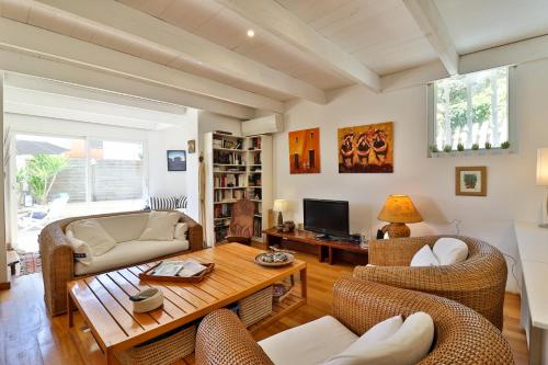 a living room with a couch and a table at Les Chambres d'Hôtes du Grand Mornas in Carry-le-Rouet