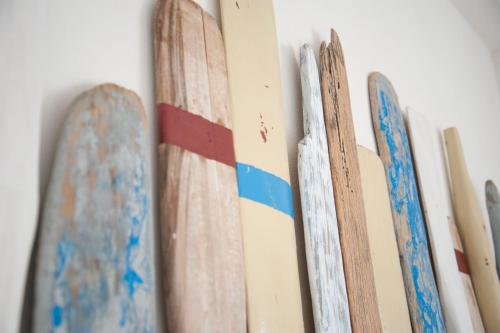 a group of surfboards hanging on a wall at Sottovento Marzamemi Rooms&Relax in Marzamemi