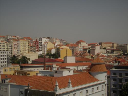 a view of a city with buildings and roofs at Hotel Excelsior in Lisbon