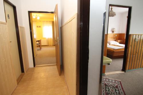 a hallway leading to a room with a bedroom at Chata Javorina in Javorník