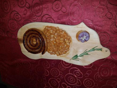 a wooden spoon filled with beans on a table at Pensiunea Mayumi Moneasa in Moneasa