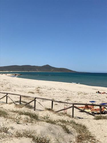 a person laying in a boat on a beach at b&b Franzisca in Torpè