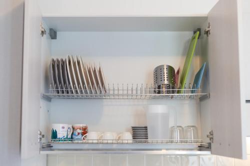 a kitchen cupboard with dishes and utensils at Casa Rosanna in Maiori