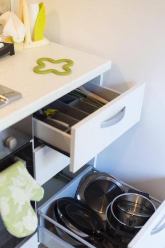 an open kitchen drawer with pots and pans in it at Casa Rosanna in Maiori