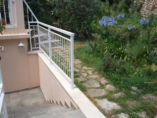 a staircase leading up to a house with flowers at Room & Apartment Saint John in Dubrovnik